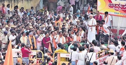 Senior RSS leader Kalladka Prabhakar Bhat addresses the gathering during a protest rally against the proposed Jesus Christ statue in Kanakapura on Monday  | express