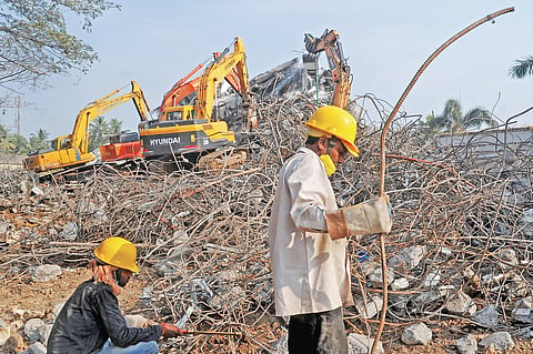 Workers removing steel rods from the debris at now-demolished Holy Faith  H2O | Express