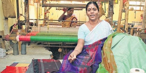 A weaver displays sarees made of beach wood and banana fibre. (Photo | Martin Louis, EPS)