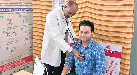 A medical officer examining a passenger at the Coimbatore International Airport on Saturday | Express