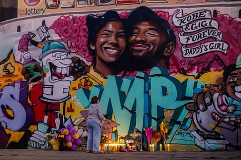 A woman looks at a mural by the artists Muck Rock and Mr79lts showing Kobe Bryant and his daughter Gianna Bryant, who were killed with seven others in a helicopter crash on January 26, in Los Angeles. (Photo | AFP)