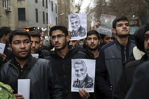 Protesters hold up posters of General Qassem Soleimani while mourning during a demonstration over the US airstrike in Iraq that killed the top army officer in Tehran (Photo| AFP)