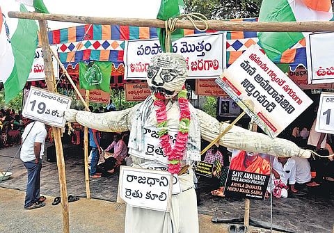 An effigy of a capital farmer put up as part of protest against shifting of capital, in Amaravati on Sunday I P Ravindra Babu
