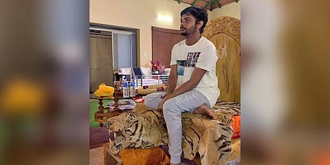 Photo of the self-styled spiritual guru sitting on a tiger pelt