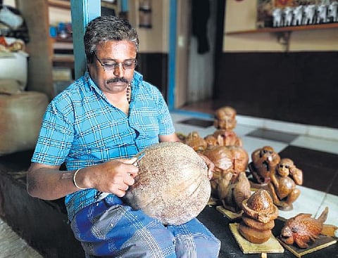 Jagadish Bhavikatti hard  at work carving  an art piece