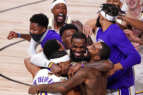 Los Angeles Lakers' LeBron James (23) celebrates with his teammates after the Lakers defeated the Miami Heat  (Photo | AP)