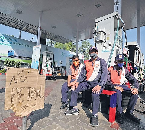 Indian Oil employees sit at a dry fuel station in Jammu| pti