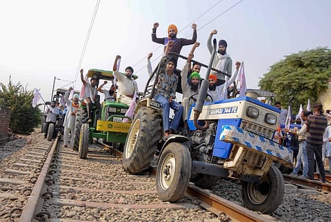 Farmers raise slogans as they block train tracks with tractors on the twentieth day of their ongoing 'Rail Roko' protest. (File | PTI)