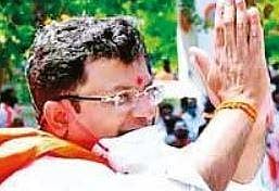 BJP candidate Rajesh Gowda greetsvoters during a rally in Sira