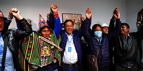 Bolivian presidential candidate Luis Arce, the leftist heir to former leader Evo Morales, said his country had 'recovered democracy' after an exit poll from TV station Unitel indicated he had won the election in the first round with 52.4% of the vote. (Photo | AP)