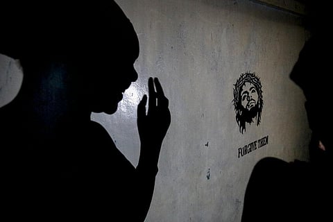 A teenage girl who became a sex worker after schools in Kenya were closed in March due to virus restrictions, casts a shadow on wall of rented room where she and others work in Nairobi. (Photo | AP)