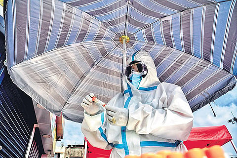 A health worker collects samples for Covid testing at the Kalasipalyam Bus Stand in Bengaluru on Saturday. (Photo | Shriram BN/EPS)