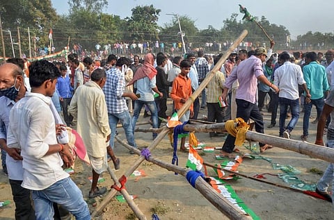 Supporters walk through a broken barricade after Rashtriya Janata Dal RJD leader Tejashwi Prasad Yadav addressed a rally in support of a Congress candidate. (Photo | PTI)