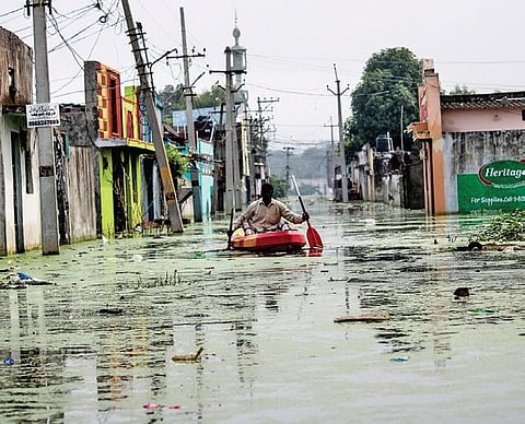 A man uses a boat to wade through high levels of floodwaters at Osman Nagar  in Hyderabad | vinay madapu