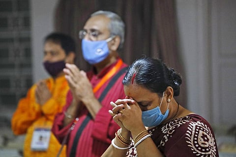 Members of the festival organizing team at the Kali Bari Hindu temple pray via live transmission on the first day of Durga Puja celebrations in New Delhi, India, Thursday, Oct. 22, 2020. (Photo | AP)