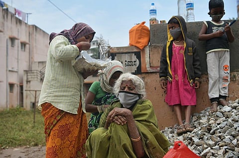 People pick up pieces in at Dattatreya Nagar  and Guruduttnagar in Bengaluru on Saturday. (Photo | Meghana Sastry, EPS)