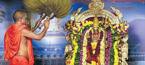 A priest performing Pavalimpu Seva to Goddess Kanaka Durga adorned as  Sri Durga Devi at Indrakeeladri in Vijayawada. (Photo | Prasant Madugula, EPS)