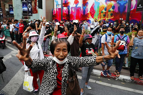 Pro-democracy protesters gather, flashing three-fingered salutes near a main shopping district in Bangkok, Thailand, Sunday, Oct. 25, 2020. (Photo | AP)