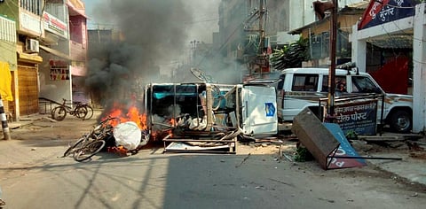 Vehicles go up in flames after it was set on fire by an angry mob during a protest over recent police firing during a Durga Puja event in Munger Thursday. (Photo | PTI)