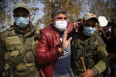 Police detain an activist of Peoples Democratic party (PDP) protesting against new land laws that allows any Indian citizen to buy land in Srinagar, Thursday, Oct. 29, 2020. (Photo | AP)