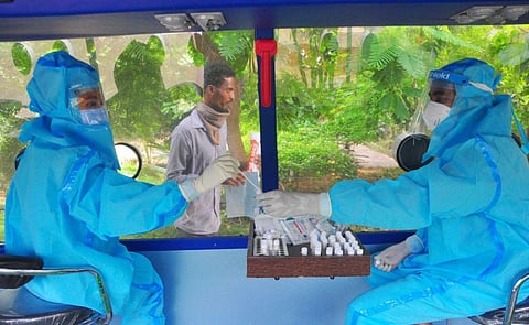 Health worker collecting Samples in iMASQ buses. (Photo | G Satyanarayana, EPS)