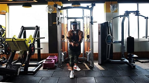A youth wearing face shield does exercises at a gym as authorities allowed the reopening of gyms and yoga centres. (Photo | Shekhar Yadav/EPS)