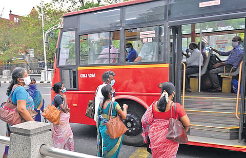 Government staff boarding a MTC bus in Chennai.| DEBADATTA MALLICK