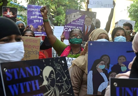 Activists hold placards and shout slogans during a protest against the death of Hathras gang rape victim. (Photo | PTI)