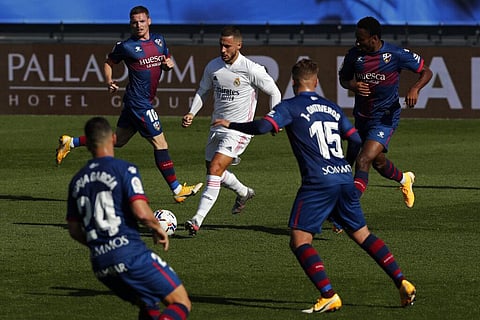 Real Madrid's Eden Hazard, center, runs with the ball next to Huesca defenders during the Spanish La Liga match. (Photo | AP)