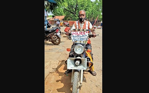D Srinivasa Prasad on his motorcycle with the public safety and first-aid  sign board. | Express