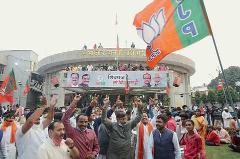 BJP workers celebrate the party's victory in Madhya Pradesh Assembly by-elections at BJP State headquarters in Bhopal Tuesday Nov. 10 2020. (Photo | PTI)