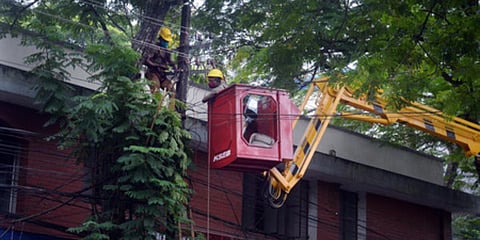 KSEB officials using a crane to lift workers to do repair works in the electric line here at Poojappura, Thiruvananthapuram. (Photo| Vincent Pulickal, EPS)