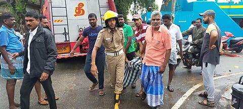 TNFRS men and locals removing a body from the site. (Photo | EPS)
