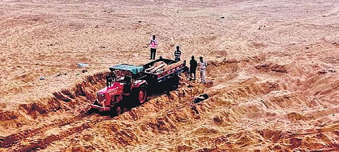 A tractor involved in illegal sand mining on the banks of Rushikulya river near Mahachai village 