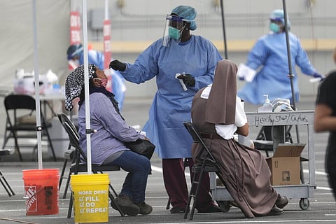 A health care worker administers a COVID-19 test at a site sponsored by Community Heath of South Florida in Homestead, Fla. (Photo | AP)