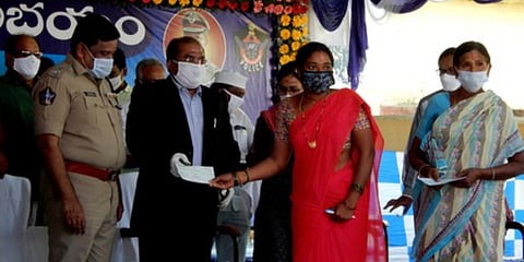 Krishna collector A Md Imtiaz and SP M Ravindranath Babu distribute compensation  to farmers at Chatrai village. (Photo| EPS)