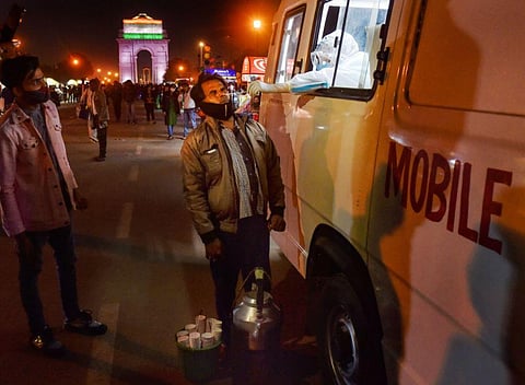 A health worker collects samples for COVID-19 testing from a mobile van, organised by NDMC, at Rajpath in New Delhi. (Photo | PTI)