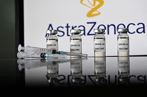An illustration picture shows vials with Covid-19 Vaccine stickers attached and syringes with the logo of British pharmaceutical company AstraZeneca. (Photo | AFP)