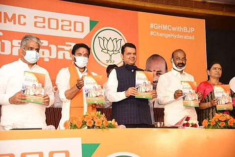 Former Maharashtra CM Devendra Fadnavi releasing party manifesto for GHMC polls on Thursday (Photo | Twitter/  #GHMCElections2020)