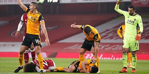 Players gesture to medical staff after a head clash between Arsenal's David Luiz, bottom left, and Wolverhampton Wanderers' Raul Jimenez during the EPL match at Emirates Stadium. (Photo | AP)