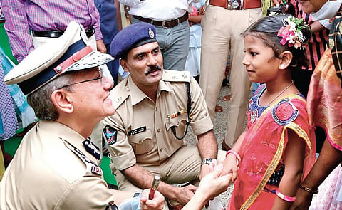 DGP Gautam Sawang speaking to Himabindu during a surprise visit  to Good Shepherd Missionary School in Tadepalli on Tuesday | Express