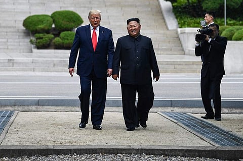 North Korea's leader Kim Jong Un walks with US President Donald Trump north of the Military Demarcation Line. (File Photo | AFP)