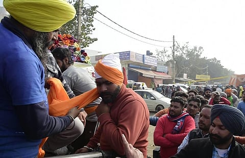 Sikh supporters tie turbans to non-Sikhs at farmer's protest against the Center's new farm laws at Singhu border in New Delhi Tuesday Dec 15 2020. (Photo | PTI)