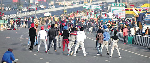 Young farmers play volleyball on a deserted NH 24 at the Ghazipur border during their protest. (Photo | Parveen Negi, EPS)