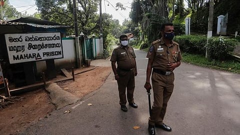 Sri Lankan police officers stand guard at the entrance to the Mahara prison complex following an overnight unrest in Mahara, outskirts of Colombo, Sri Lanka. (File photo | AP)
