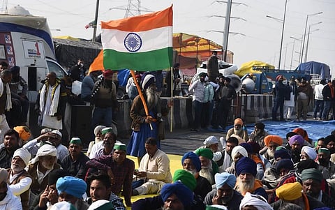 A Nihang holds the Tricolor at Ghazipur border during farmers protest against Centres agri-laws in New Delhi Sunday Dec. 20 2020. (Photo | Parveen Negi/EPS)