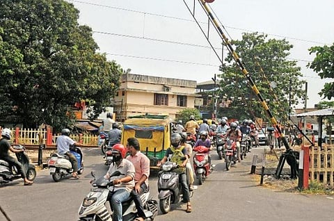 Vehicles rushing through Vaduthala railway crossing as soon after the gate is opened. (Photo | A Sanesh, EPS)