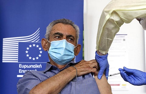 Andreas Raounas, 84, the first patient in Island receives from a nurse the vaccine of Pfizer BioNtech against the COVID-19, at a care home in Nicosia, Cyprus. (Photo | AP)