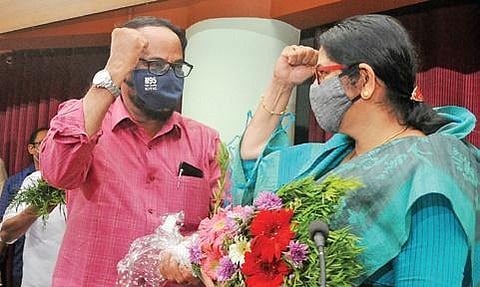 Former Kozhikode district panchayat president Babu Parassery greets his successor Kanathil Jameela | Express