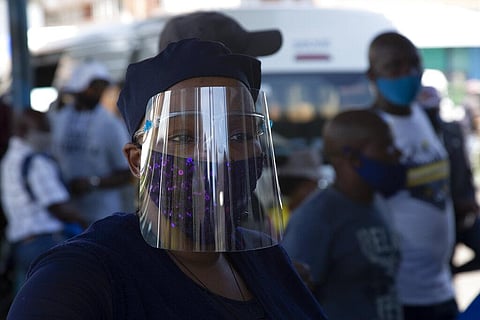 In this Thursday, Dec. 24, 2020 file photo people wear face masks to protect against COVID-19 before boarding a minibus taxi in Johannesburg. (Photo | AP)